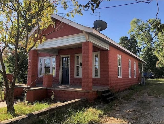 view of side of property with covered porch