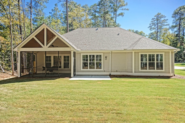 back of property with a sunroom and a yard