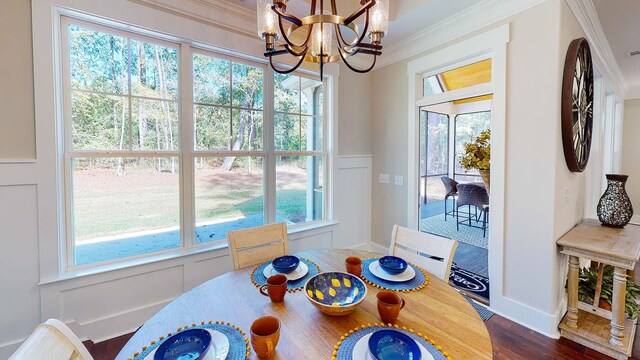 149 Cypress Dr, Mccormick, SC 29835 - dining area with a wainscoted wall, crown molding, a decorative wall, dark wood-style flooring, and a chandelier