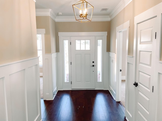 149 Cypress Dr, Mccormick, SC 29835 - foyer entrance featuring dark wood-style flooring, ornamental molding, a decorative wall, and a chandelier
