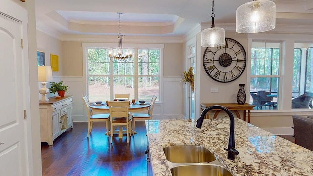 149 Cypress Dr, Mccormick, SC 29835 - dining area with a chandelier, a raised ceiling, a decorative wall, and dark wood-style floors