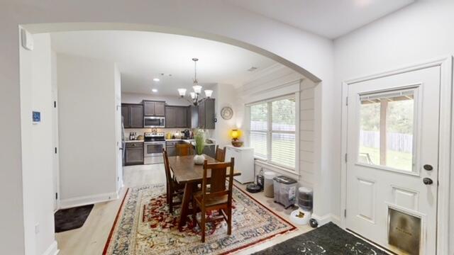 532 Nassau Pass, North Augusta, SC 29860 - dining area featuring recessed lighting, an inviting chandelier, light wood-style floors, baseboards, and arched walkways