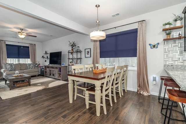 dining area featuring dark wood-type flooring, ceiling fan, and plenty of natural light