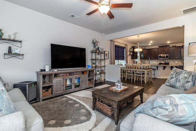 living room featuring wood-type flooring and ceiling fan