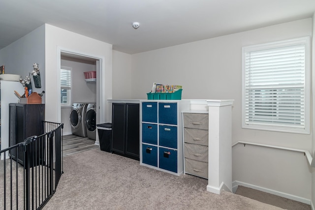 interior space with a crib and washer and clothes dryer