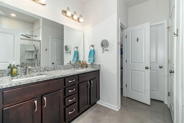 bathroom with tile patterned floors, vanity, and an enclosed shower