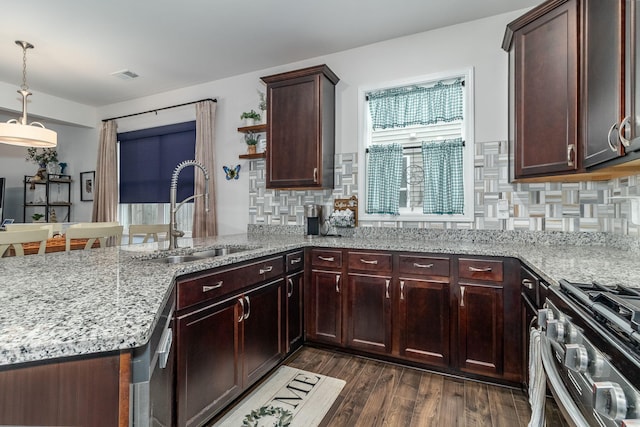 kitchen featuring appliances with stainless steel finishes, kitchen peninsula, sink, and backsplash