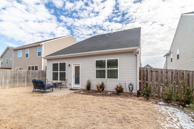 back of property with a patio