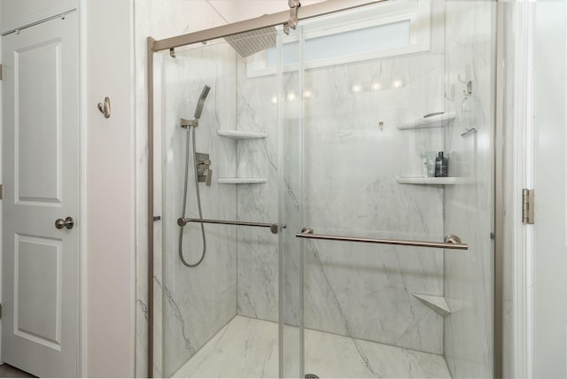 bathroom with a shower with door