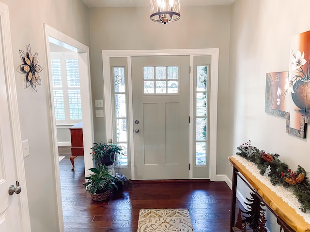 153 Cumberland Dr, Mccormick, SC 29835 - foyer with baseboards, a notable chandelier, and dark wood-type flooring