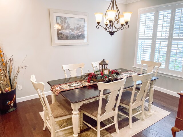 dining space with plenty of natural light, dark wood-type flooring, and an inviting chandelier