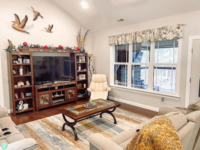 living room with dark hardwood / wood-style floors and lofted ceiling