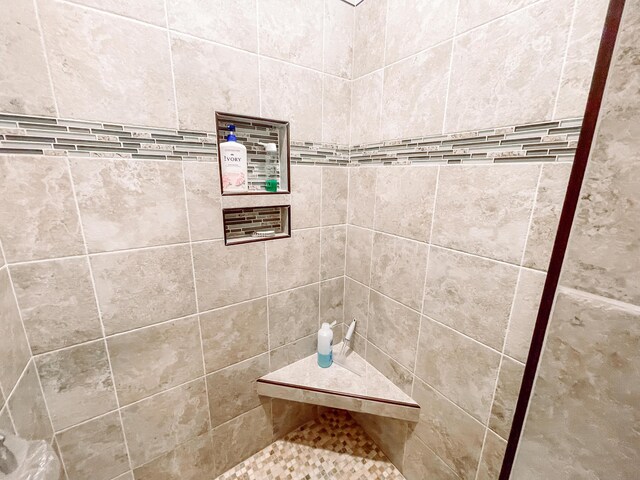 bathroom with tiled shower