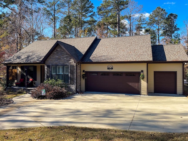 153 Cumberland Dr, Mccormick, SC 29835 - view of front of property featuring roof with shingles, an attached garage, driveway, and stone siding