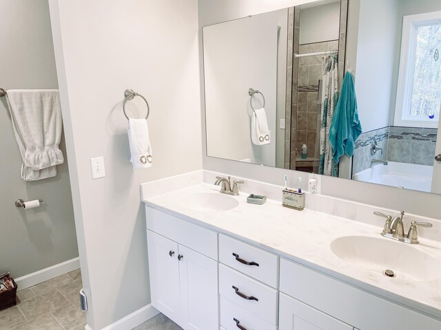 bathroom featuring tile patterned flooring, vanity, and shower with separate bathtub