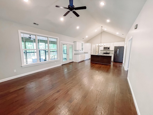 153 Cumberland Dr, Mccormick, SC 29835 - unfurnished living room with dark wood-style flooring, baseboards, visible vents, and ceiling fan with notable chandelier