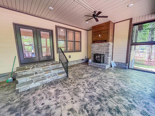 153 Cumberland Dr, Mccormick, SC 29835 - unfurnished living room featuring french doors, wooden walls, and a wealth of natural light