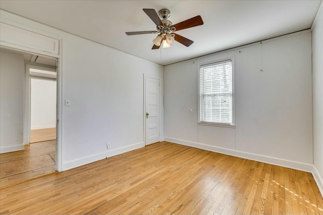 empty room with ceiling fan and light wood-type flooring