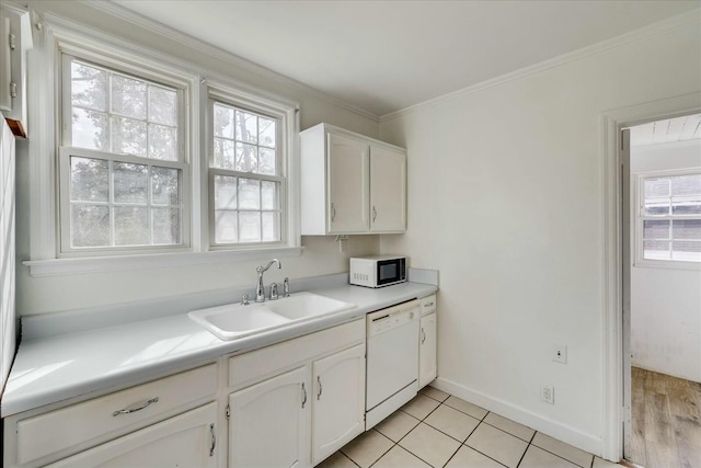 kitchen with plenty of natural light, dishwasher, sink, and white cabinets