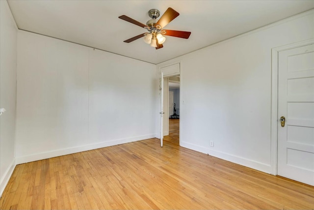 spare room with ceiling fan and light wood-type flooring