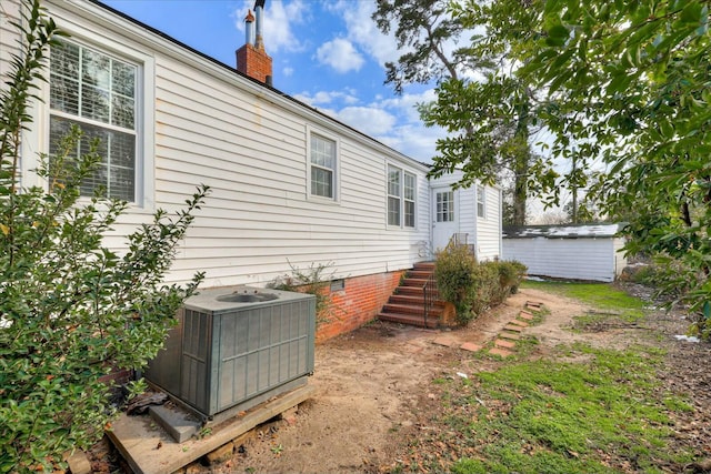 exterior space featuring a storage unit and central air condition unit