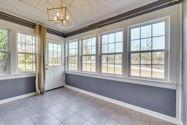 unfurnished sunroom featuring wood ceiling, a healthy amount of sunlight, and a notable chandelier