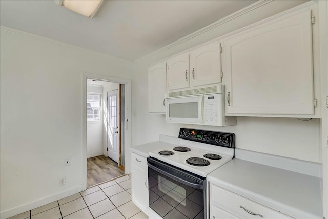 kitchen with white cabinetry, range with electric cooktop, and light tile patterned floors