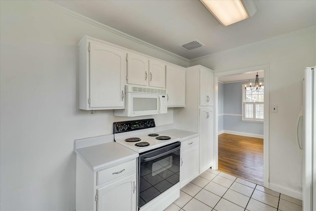 kitchen with white cabinetry, an inviting chandelier, light tile patterned floors, ornamental molding, and white appliances