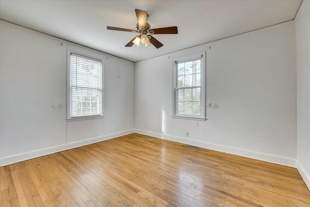 empty room with ceiling fan, light hardwood / wood-style flooring, and a wealth of natural light