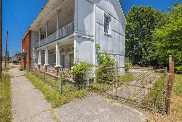 view of home's exterior featuring a porch and a balcony