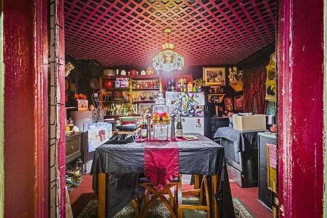 carpeted dining room with bar area