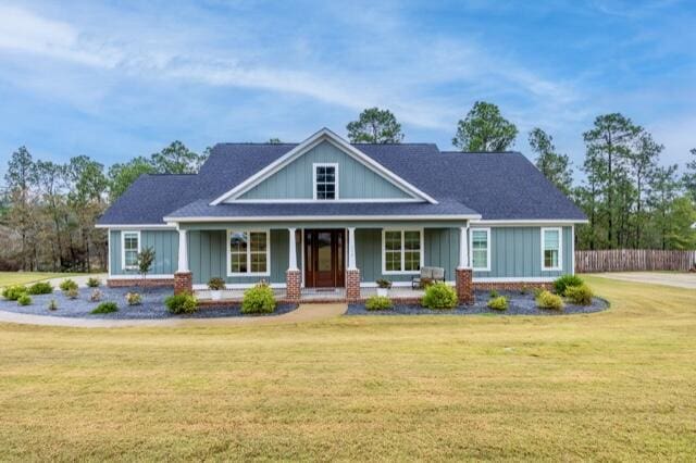 craftsman-style house featuring a front yard and a porch