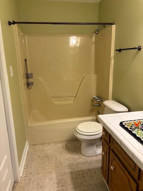 bathroom with bathtub / shower combination and toilet