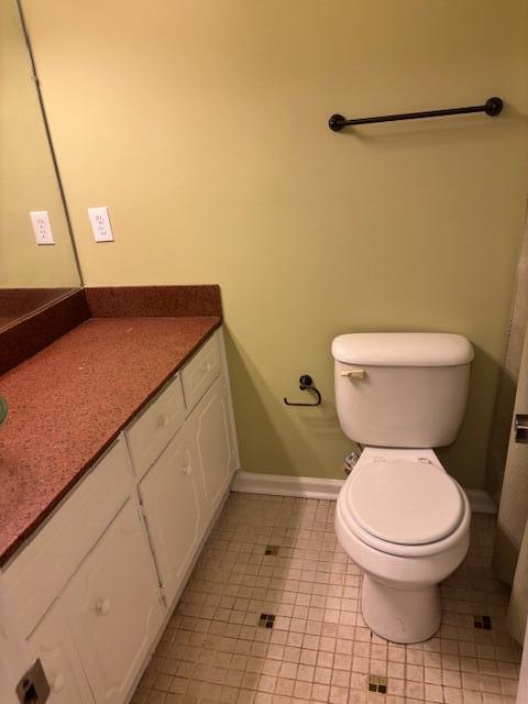 bathroom featuring tile patterned floors, vanity, and toilet