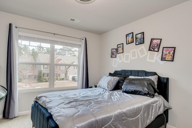 carpeted bedroom featuring visible vents and baseboards