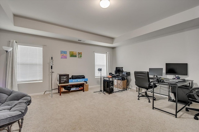 carpeted office with a raised ceiling, visible vents, and baseboards