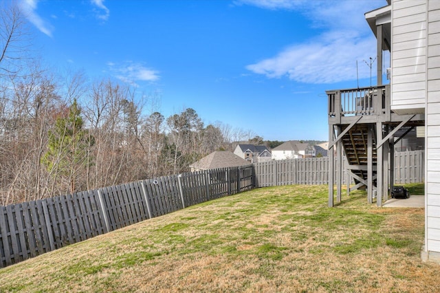 view of yard featuring a fenced backyard and stairway