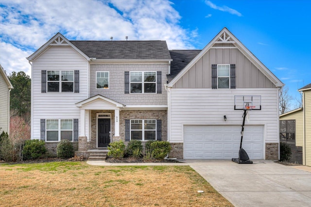 view of front facade with a garage, driveway, board and batten siding, and a front yard