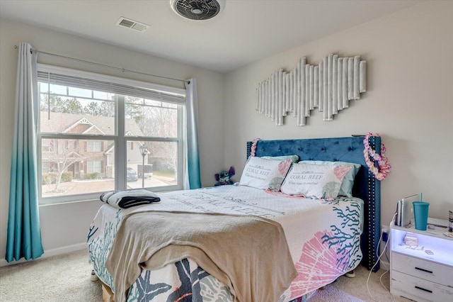 carpeted bedroom featuring baseboards and visible vents