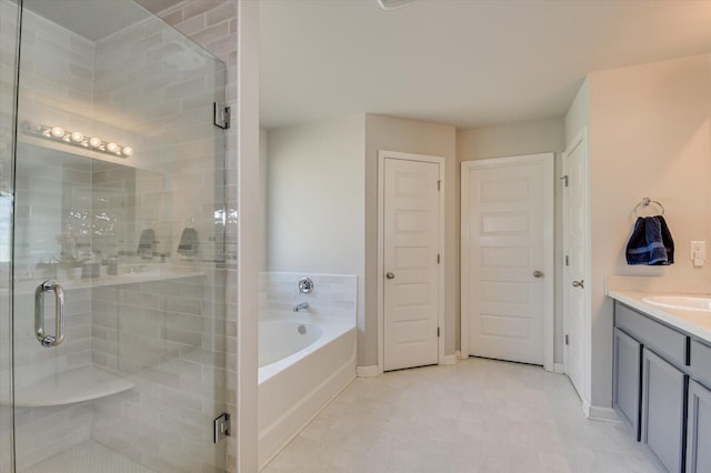 full bathroom featuring a bath, a closet, vanity, and a stall shower