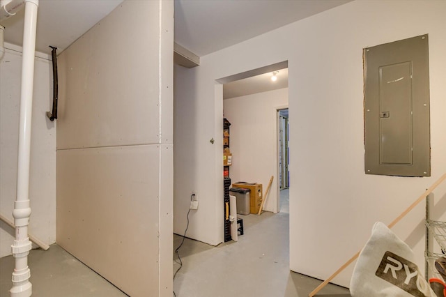 corridor with finished concrete floors and electric panel