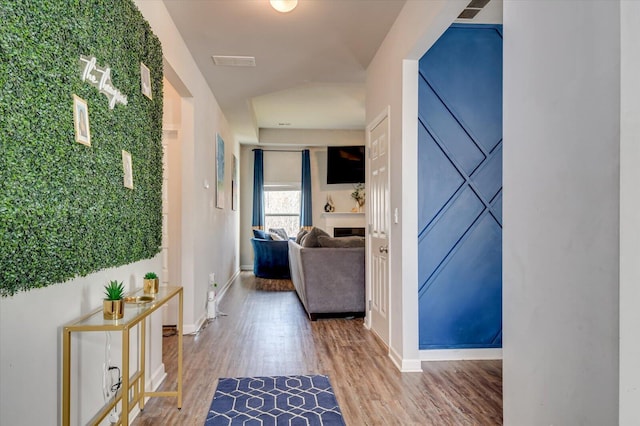 hall with wood finished floors and baseboards