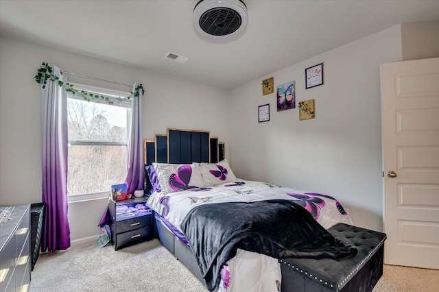 bedroom with light carpet, visible vents, and baseboards