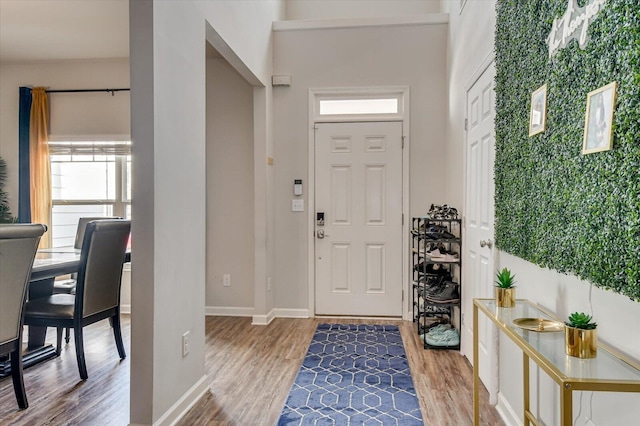 entryway with wood finished floors and baseboards