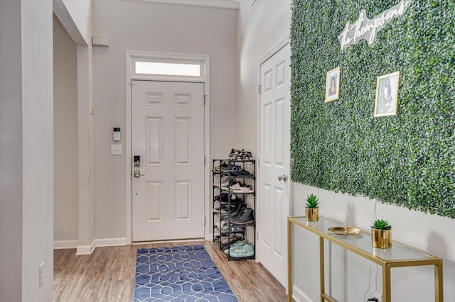 entryway featuring wood finished floors and baseboards