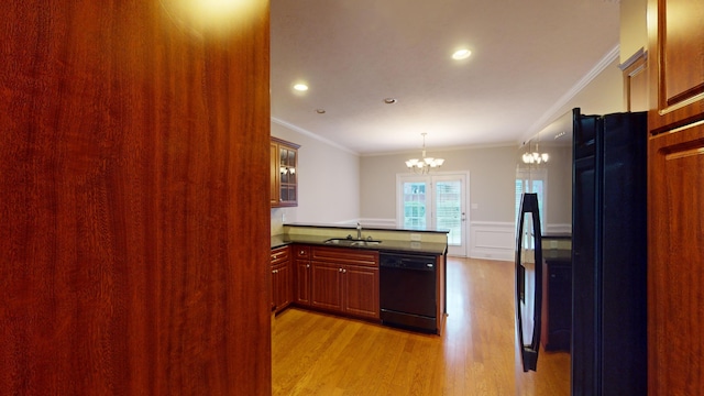 135 Coach Ln, Augusta, GA 30907 - kitchen featuring a sink, crown molding, black appliances, a chandelier, and light wood-style flooring