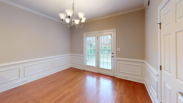 135 Coach Ln, Augusta, GA 30907 - interior space featuring light wood-style flooring, wainscoting, ornamental molding, and an inviting chandelier