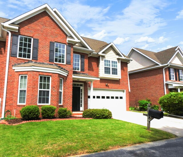 135 Coach Ln, Augusta, GA 30907 - view of front facade featuring brick siding, an attached garage, a front lawn, and concrete driveway