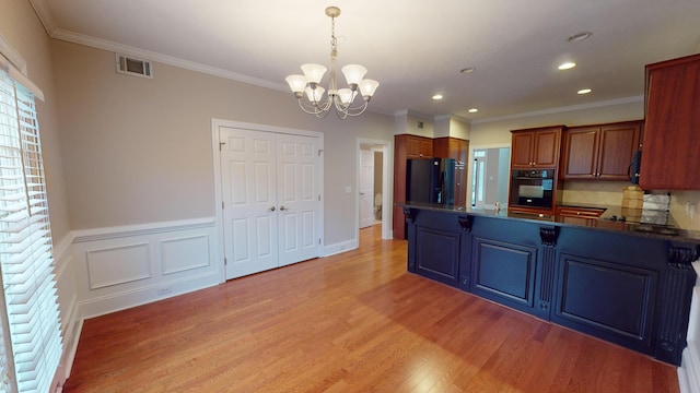 135 Coach Ln, Augusta, GA 30907 - kitchen featuring black appliances, decorative backsplash, light wood-type flooring, an inviting chandelier, and visible vents