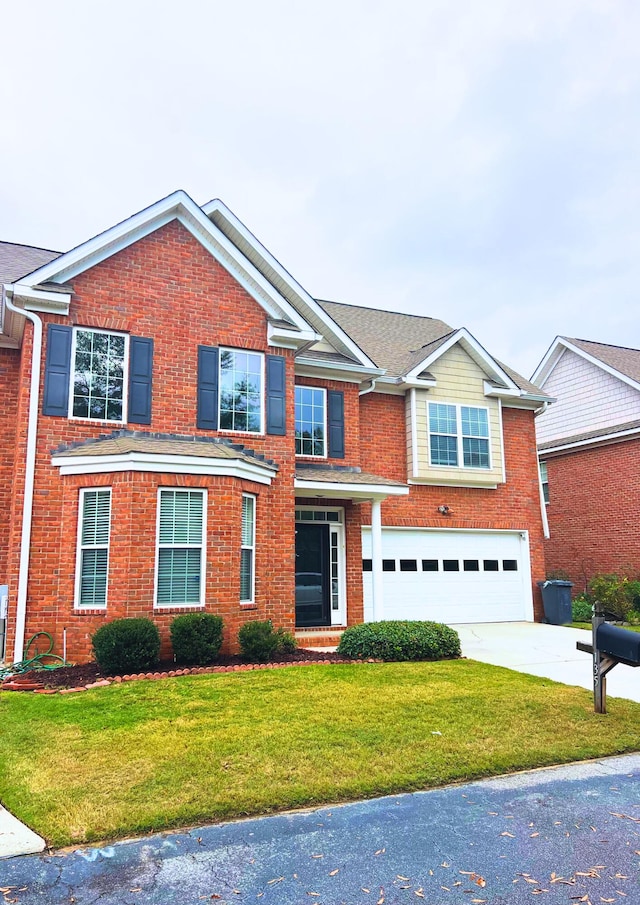 view of front of property featuring a garage and a front yard